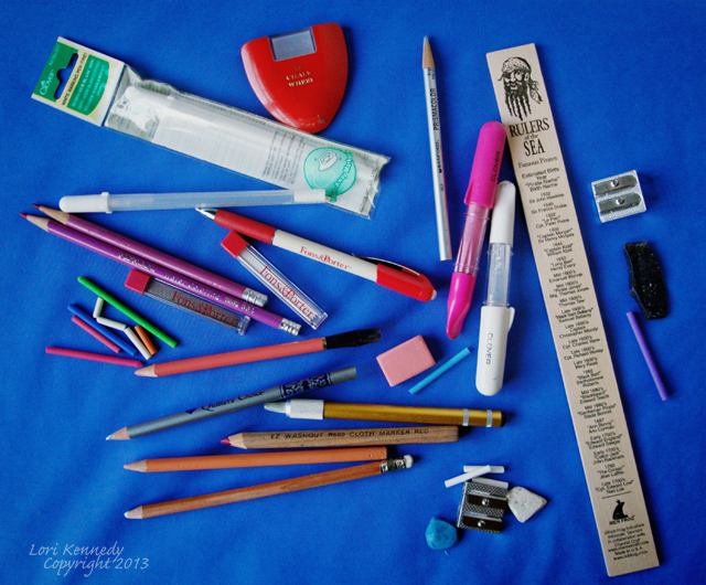 Various stationery materials laid on blue fabric