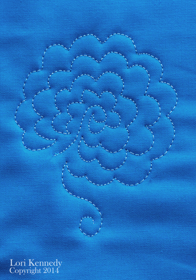 Big flower design quilted on blue fabric