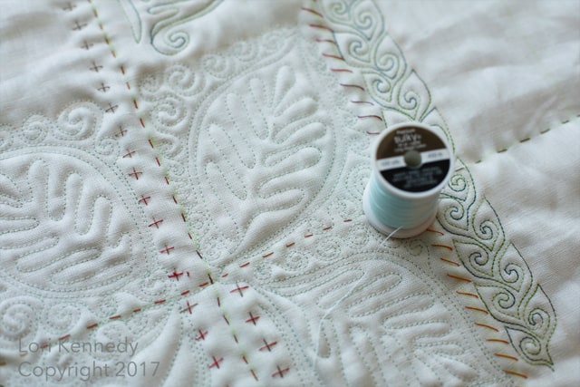 Spool of thread on a quilt