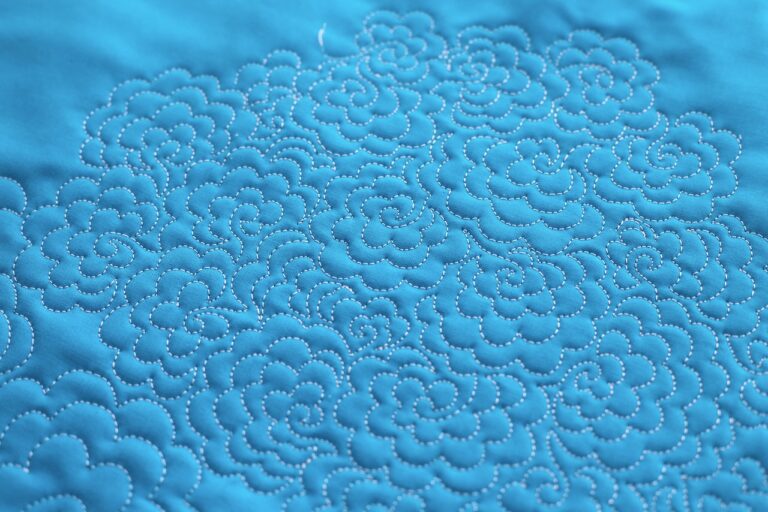 Blue fabric quilted with flowery pattern